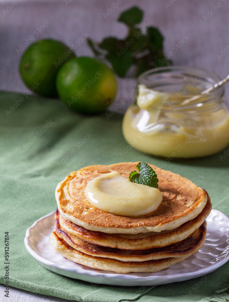 Whole grain flour fritters served with lime curd on a light background. Rustic style.