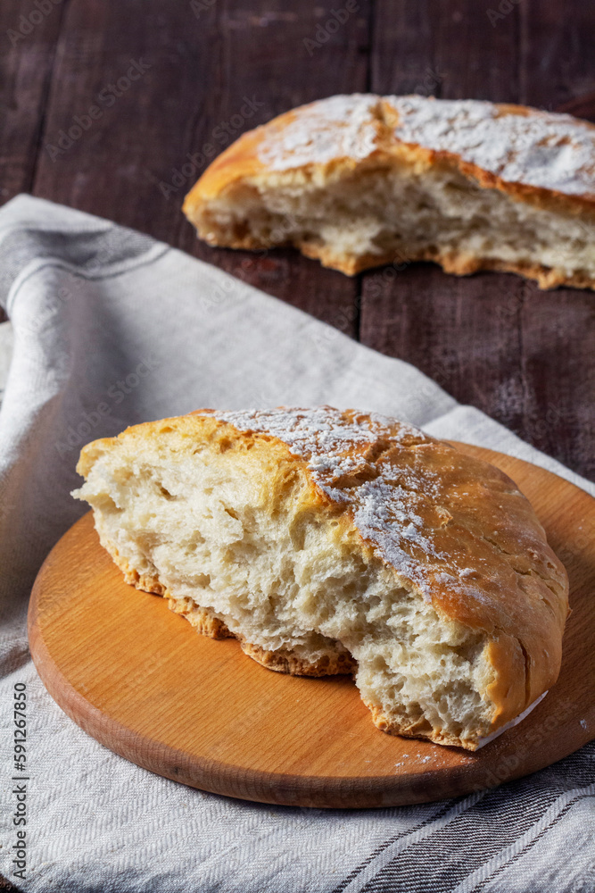 Homemade ciabatta bread with whole grain flour on a wooden background. Rustic style.