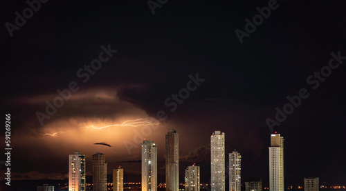 Awe-inspiring Orange Lightning Over Urban Skyline