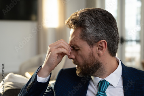Tired, headache and eye strain from laptop. Businessman with stress, burnout and fatigue eyestrain. Business man rubbing tired eyes after computer work.