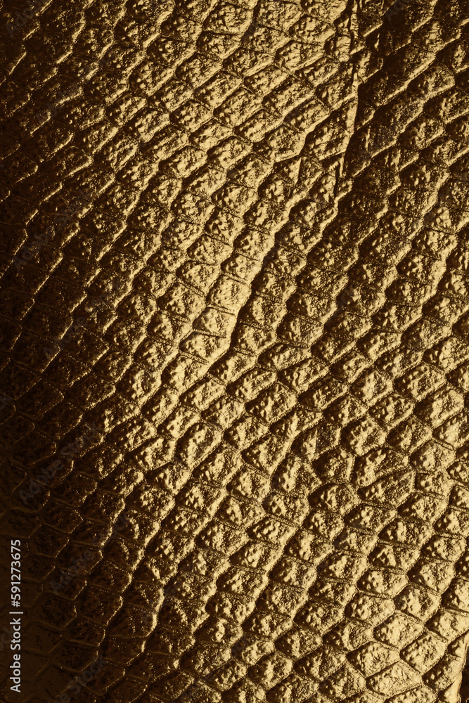 Gold and bronze litter foil paper. Abstract reptile skin imitation texture background. Gold and bronze litter foil paper. Abstract reptile skin imitation texture background.
