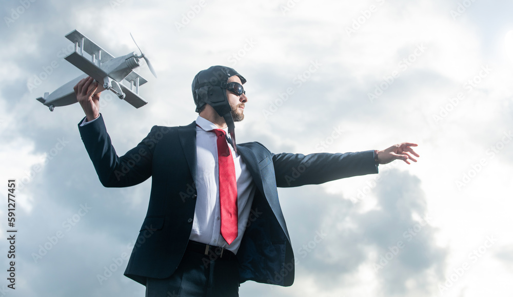 businessman in suit and pilot hat launch plane toy. concept of mission businessman in suit and pilot hat launch plane toy. concept of mission