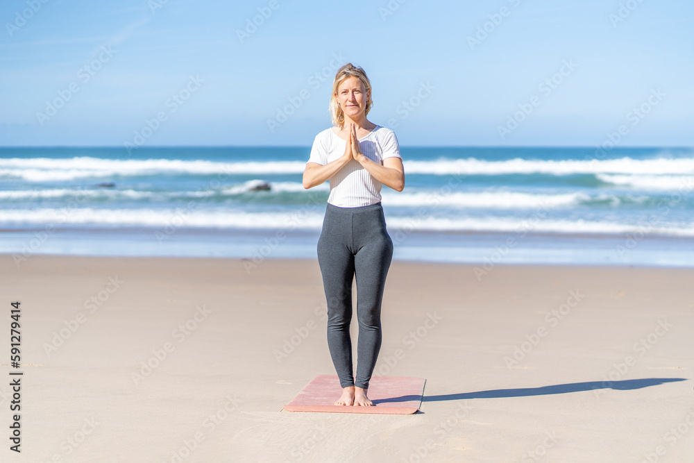Yogi woman practicing yoga meditating, doing Mountain Pose, Tadasana gesture. Healing concept