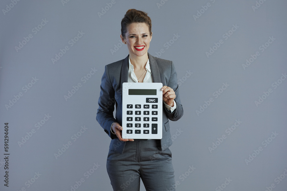 smiling trendy 40 years old woman worker isolated on gray smiling trendy 40 years old woman worker isolated on gray