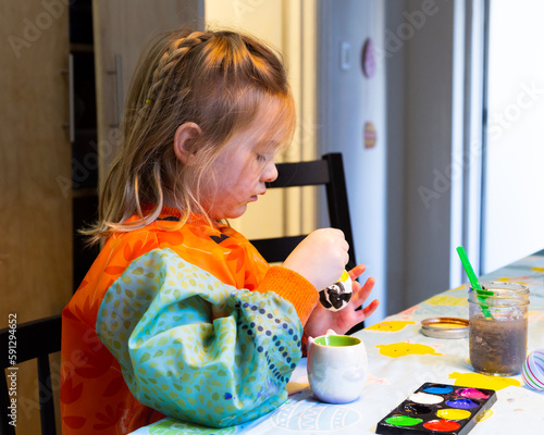Εκτύπωση καμβά Selective focus medium portrait of fair little girl in art waterproof smock pain