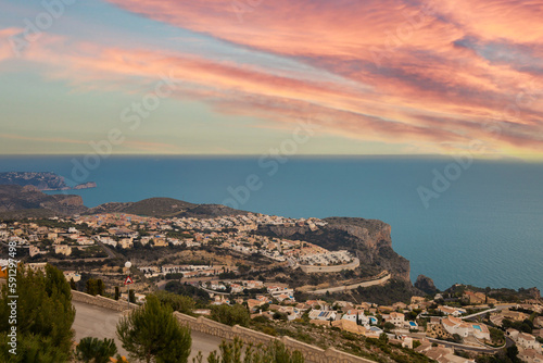 Panoramic view of Cumbre del Sol in Spain, villas on the hills and the sea at sunset