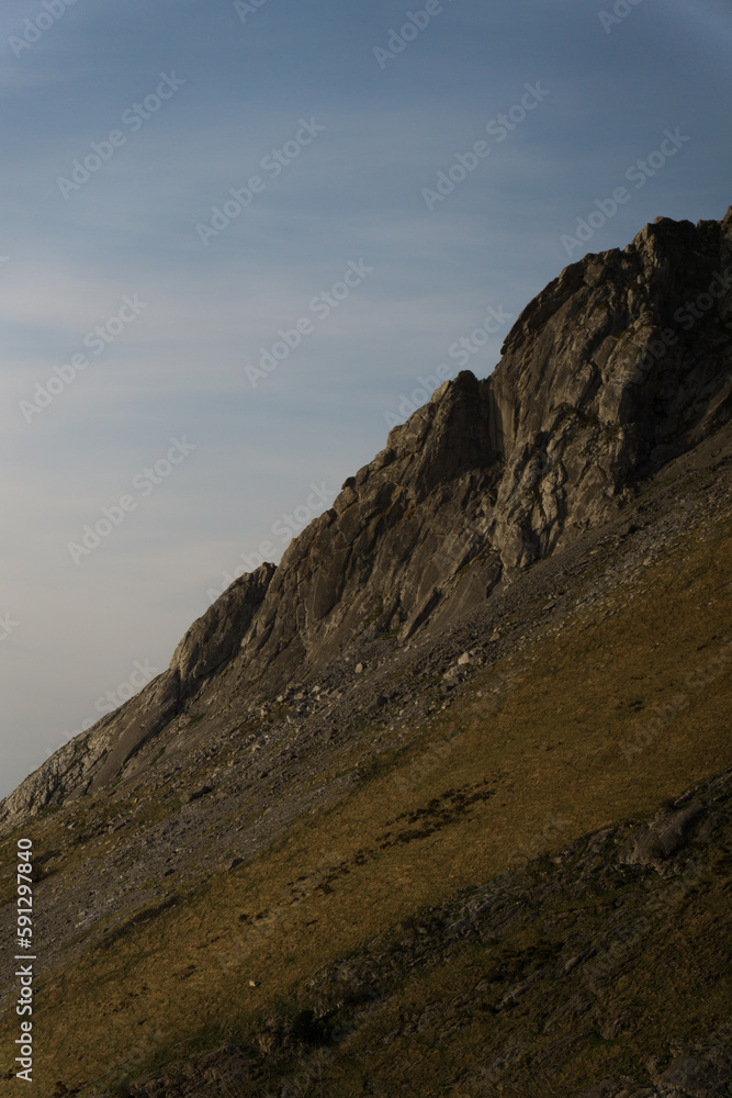 The landscape of the green mountain peak in summer. Rocky cliff.