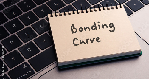 There is note book with the word Bonding Curve on a laptop. It is an eye-catching image.