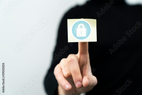 Businessman pointing at a lock icon showing cybersecurity and privacy concepts 