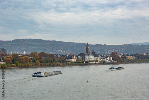 Two cargo ships on the river Rhine with the castle and the curch of Neuwied Engers in the background