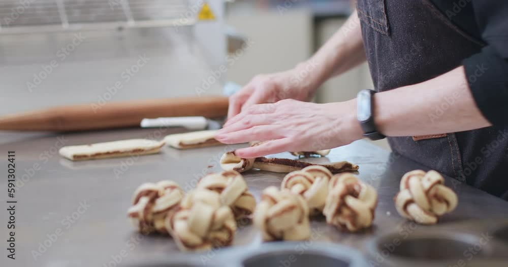 Woman baker preparing raw dough for pastry on baking manufacture. Woman baker preparing raw dough for pastry on baking manufacture.