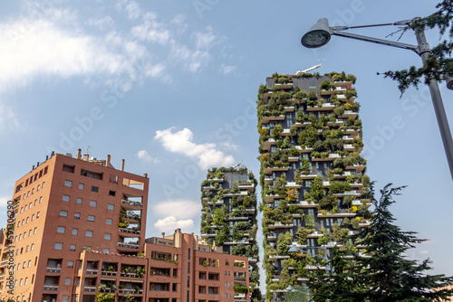 An urban building is transformed by a green facade and thriving plant life. Bosco Verticale (Vertical Forest) in Milan city, Italy