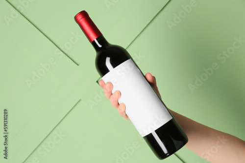 Female hand holding bottle ...