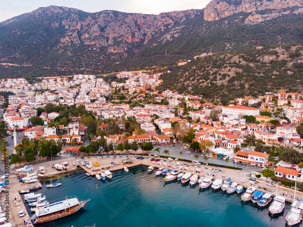 View from drone of small Turkish town of Kas on Turquoise Coast of Aegean Sea overlooking embankment and marina