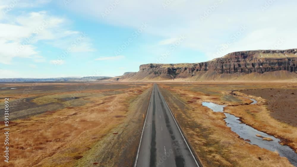 Aerial fly over Icelandic southern ring road with no cars and scenic mountains and wild landscape. Iceland road trip concept Aerial fly over Icelandic southern ring road with no cars and scenic mountains and wild landscape. Iceland road trip concept