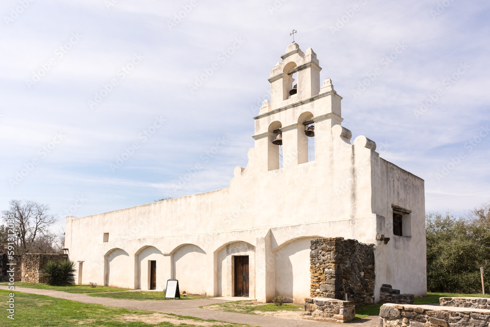 The pure white adobe of Mission San Juan bathed in sunlight, San Antonio, Texas, a UNESCO World Heritage Site. 