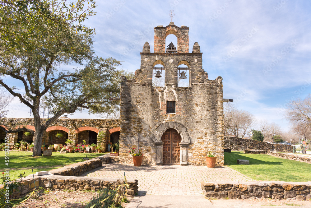 Naklejka premium The beautiful stone Mission Espada bathed in sunlight, San Antonio, Texas, a UNESCO World Heritage Site 