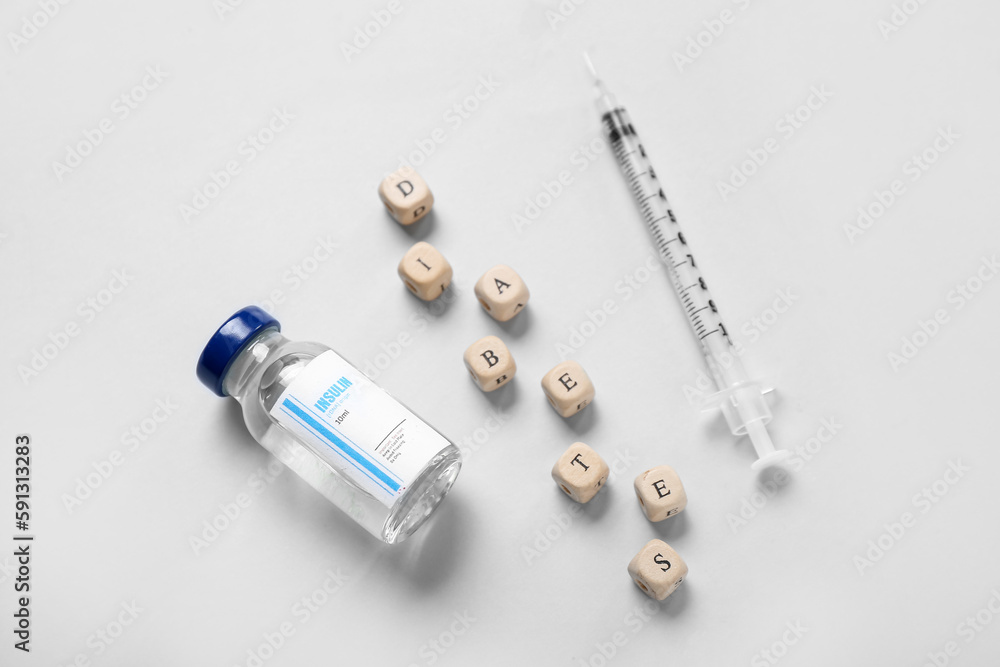Word DIABETES with insulin and syringe on grey background Word DIABETES with insulin and syringe on grey background