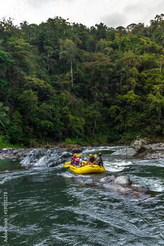 adventurous adults rafting on a raft in the middle of the jungle on the Pacuare River in Costa Rica
