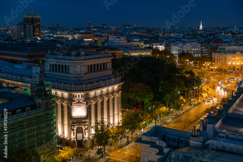 View of the skyline and cityscape of Madrid at night with Cervantes and the bank of spain illuminated at night