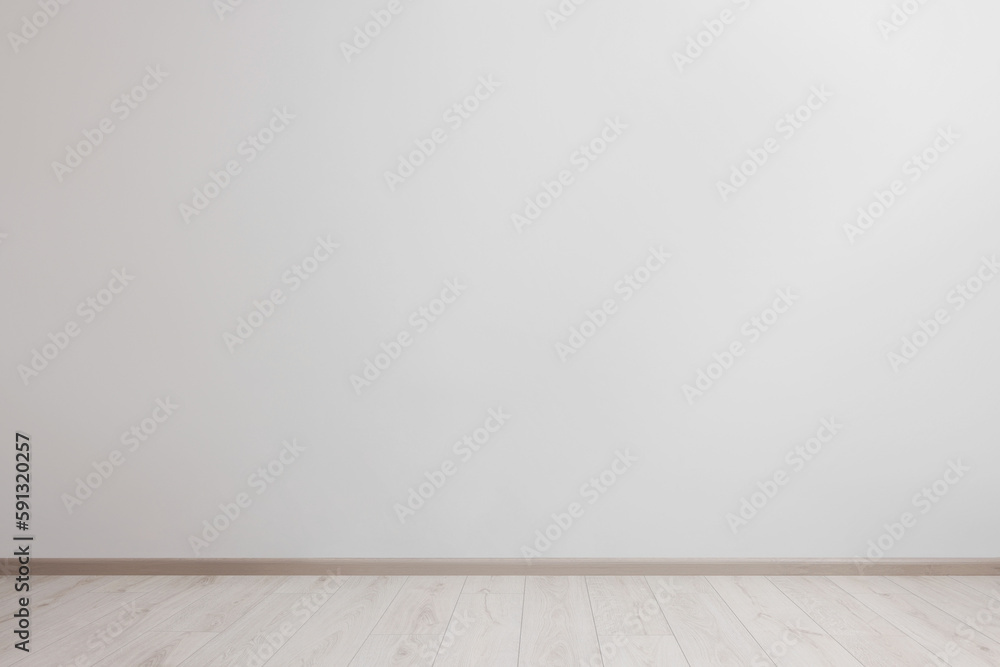 Empty room with white wall and wooden floor Empty room with white wall and wooden floor