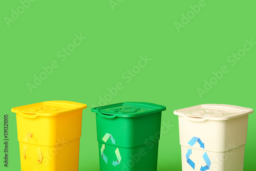 Containers for garbage on green background. Recycling concept