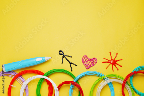Stylish 3D pen, colorful plastic filaments and different figures on yellow background, flat lay. Space for text