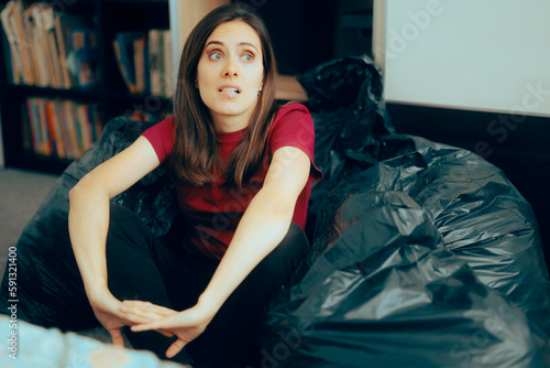 Tableau sur toile Woman Surrounded with Plastic Bags after De-cluttering and Editing her Wardrobe