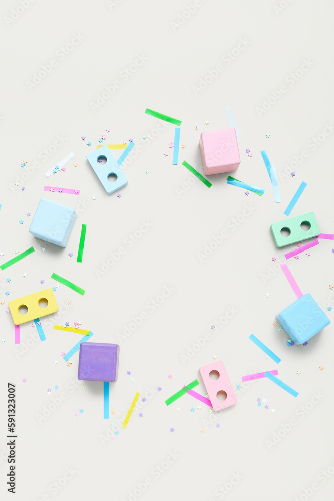 Frame made of baby blocks and confetti on beige background. Children's Day celebration Frame made of baby blocks and confetti on beige background. Children's Day celebration