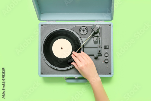 Woman with record player on...