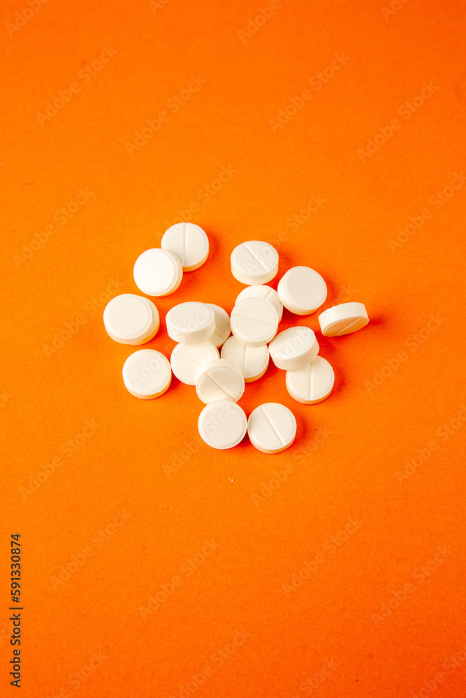 top view white pills on orange background lab disease covid- health pandemic science virus potion drug