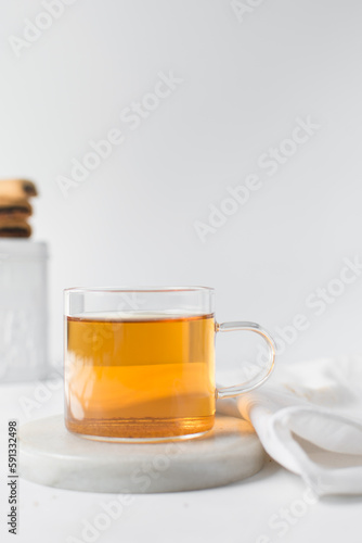 Tea in a glass cup, freshly brewed black tea in a trendy glass cup