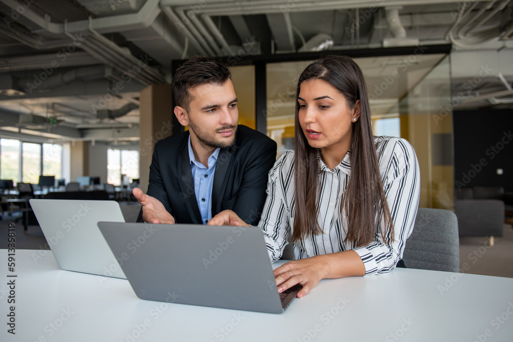 Young latin couple working using laptop sitting on the table at home. Young latin couple working using laptop sitting on the table at home.
