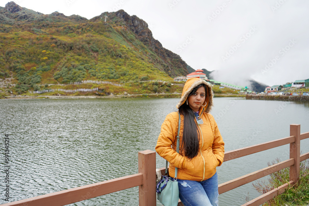 Young age Tourist Girl Standing beside Tsomgo or Changu Lake at East Sikkim During Silk Route Tour