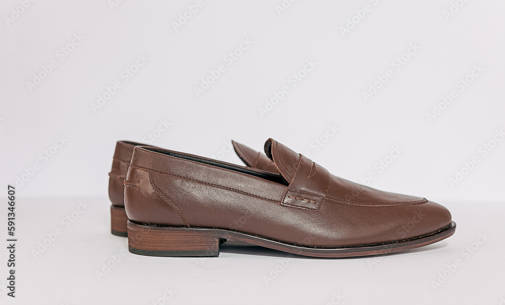 Classic male brown leather shoes isolated on a white, side view Classic male brown leather shoes isolated on a white, side view