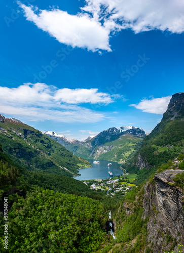 Views of Norwegian fjord landscape with snow mountains and cruise ships in Geiranger fjord, Norway