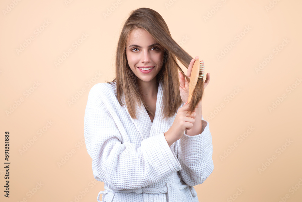 Young woman taking care with hair comb of her hair. Haircare. Pretty girl brushing hairs with comb. Beauty, hair loss products, shampoo and hair care concept.