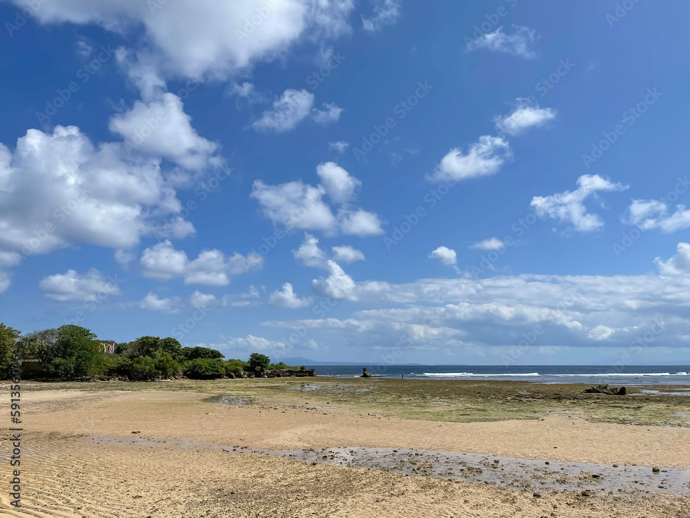 Beautiful beach with a view of the coastline blue sky and white clouds Beautiful beach with a view of the coastline blue sky and white clouds
