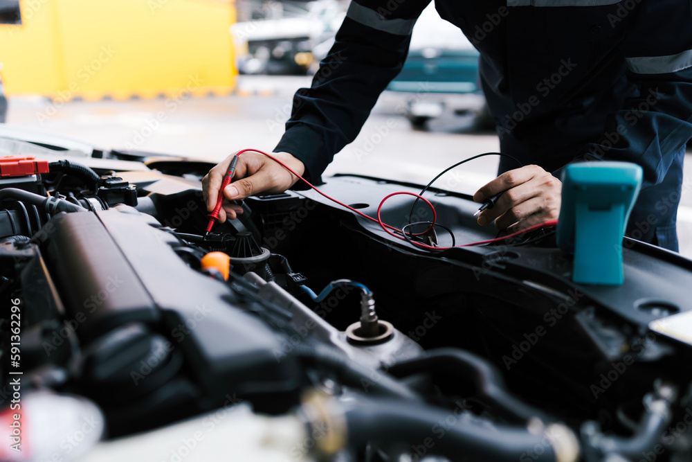 Technician Hands of car mechanic working repair in auto repair Service electric battery and Maintenance of car battery. Check the electrical system inside the car. Technician Hands of car mechanic working repair in auto repair Service electric battery and Maintenance of car battery. Check the electrical system inside the car.