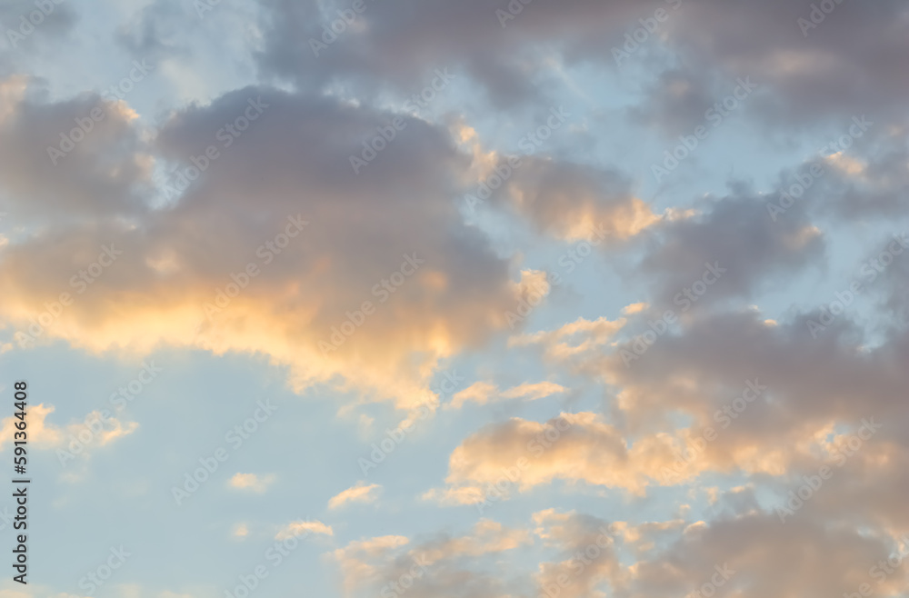 Blue sky background with golden clouds at sunset Blue sky background with golden clouds at sunset