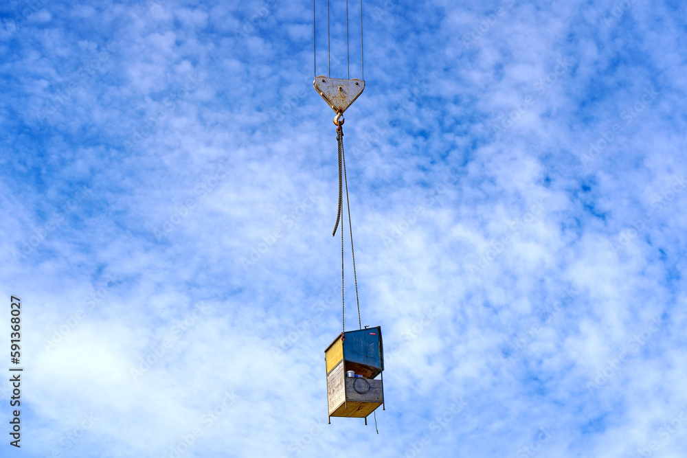 Highway construction site at City of Zürich with mobile shelter for construction plans hook and chain of crane on a cloudy spring day. Photo taken March 28th, 2023, Zurich, Switzerland. Highway construction site at City of Zürich with mobile shelter for construction plans hook and chain of crane on a cloudy spring day. Photo taken March 28th, 2023, Zurich, Switzerland.