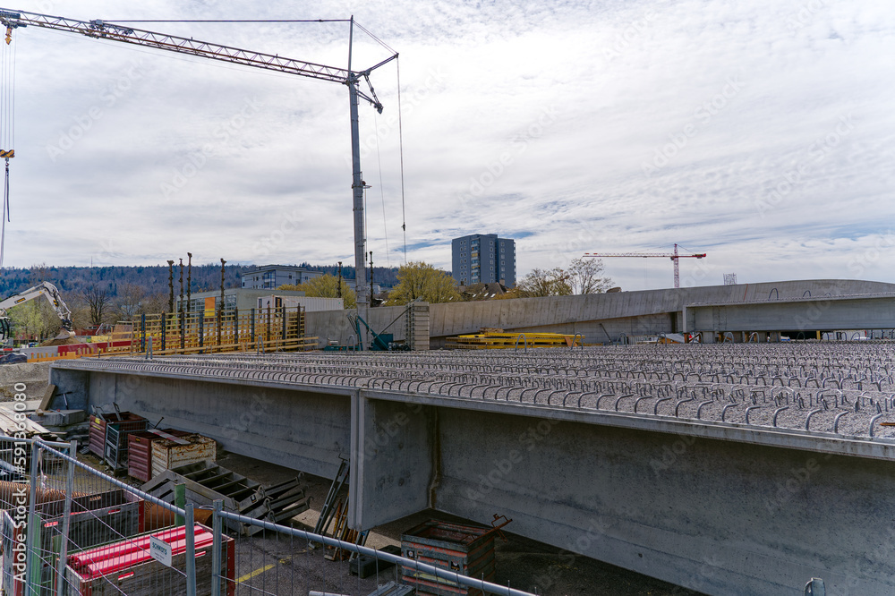Highway construction site at City of Zürich district Schwamendingen with stapled concrete girders on a cloudy spring day. Photo taken March 28th, 2023, Zurich, Switzerland. Highway construction site at City of Zürich district Schwamendingen with stapled concrete girders on a cloudy spring day. Photo taken March 28th, 2023, Zurich, Switzerland.