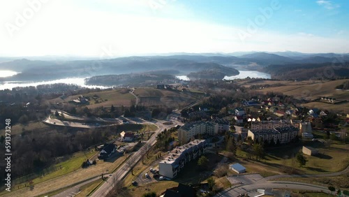 Polanczyk village and Bieszczady Mountains in Spring in Lesko County, Subcarpathian Voivodeship, in south-eastern Poland - aerial view on sunset
 photo