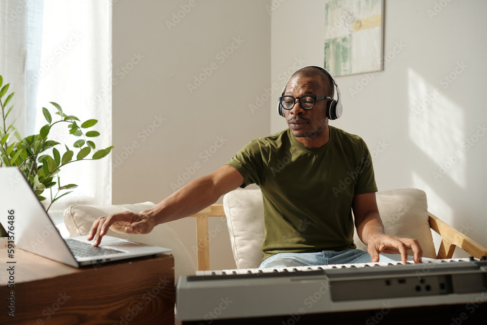 © DragonImages - Freelancer recording new music track to sell online