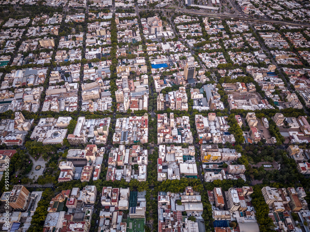 Fototapeta premium Beautiful aerial view to city buildings and green public streets