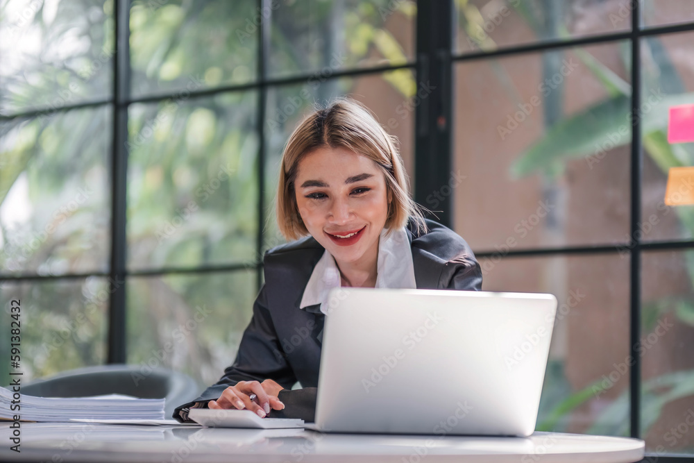 Business woman using calculator for do math finance on wooden desk in office and business working background, tax, accounting, statistics and analytic research concept.. Business woman using calculator for do math finance on wooden desk in office and business working background, tax, accounting, statistics and analytic research concept..