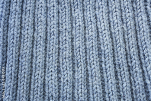 Gray knitted fabric texture for a design with room for copying text or images. Knitted knit fabric.