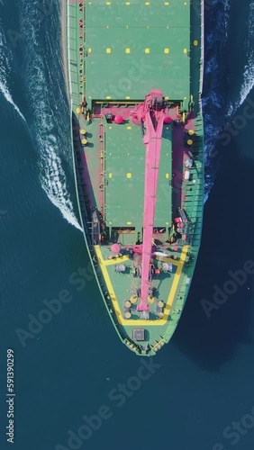 Forecastle of bulk cargo vessel cruising in sea, Aerial top dow shot photo