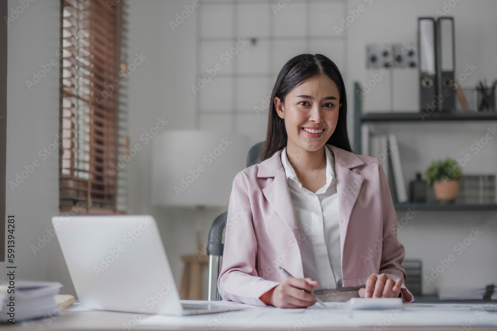 Business woman using calculator for do math finance on wooden desk in office and business working background, tax, accounting, statistics and analytic research concept.. Business woman using calculator for do math finance on wooden desk in office and business working background, tax, accounting, statistics and analytic research concept..
