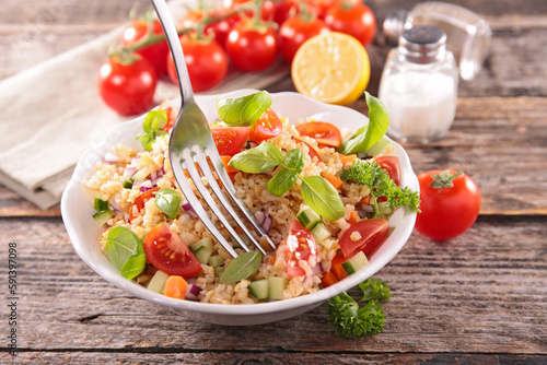 Tabbouleh, mixed vegetable salad with tomato, cucmber and basil photo